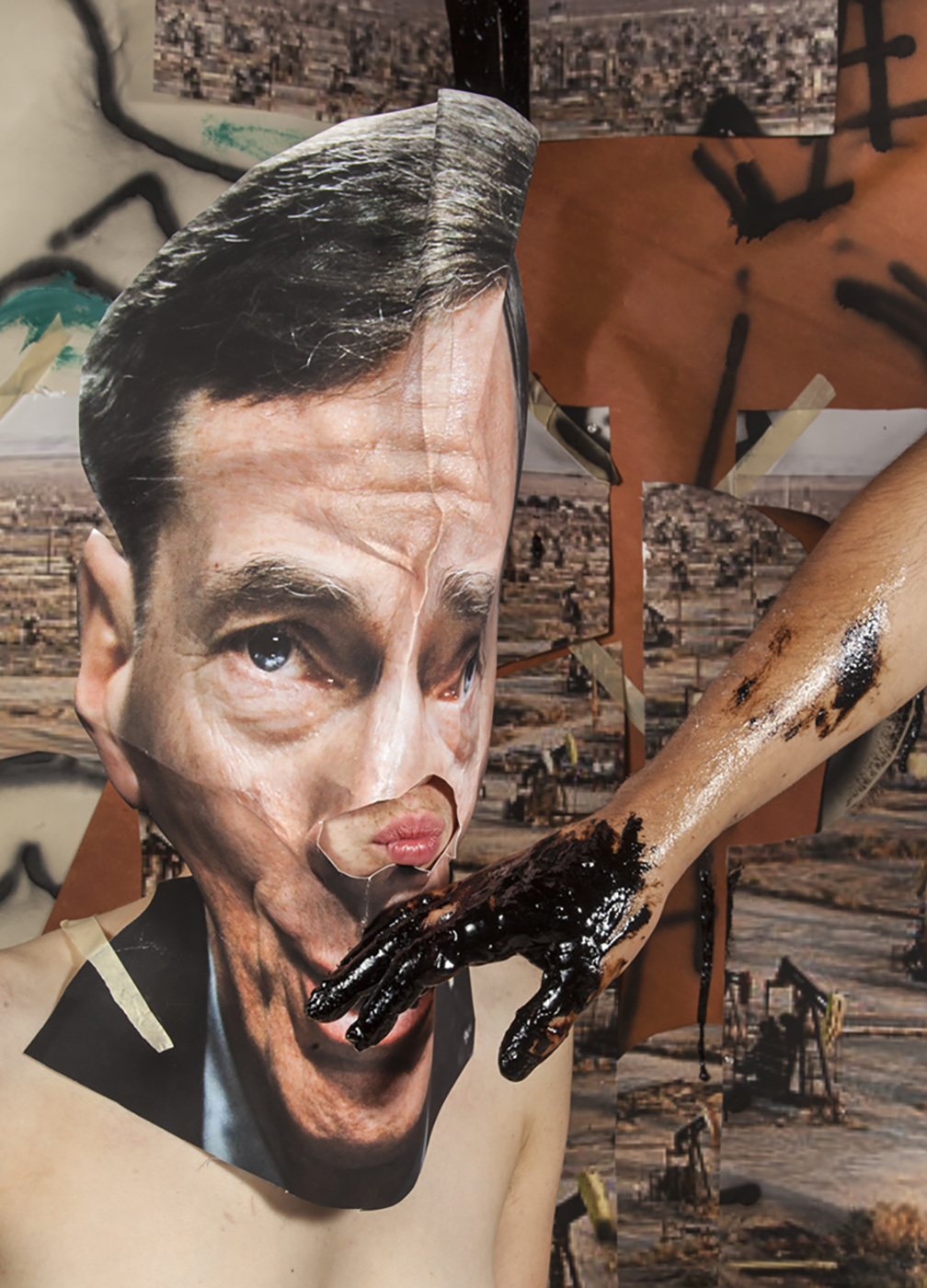 A figure wearing a mask of US politician with a black, oil-smeared hand reaching for his face in front of a collage background of an oil field.